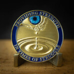 3D Antique Bronze coin with soft enamel blue border and epoxy-covered printed inset (iris) Strength in times of Struggles challenge Coin